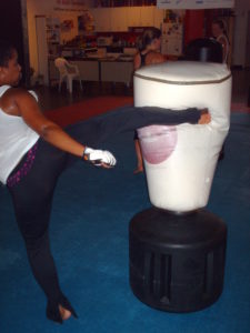 Trinity Fitness Tae Kwon Do team member demonstrating a round kick during an are you prepared? women's self defense seminar